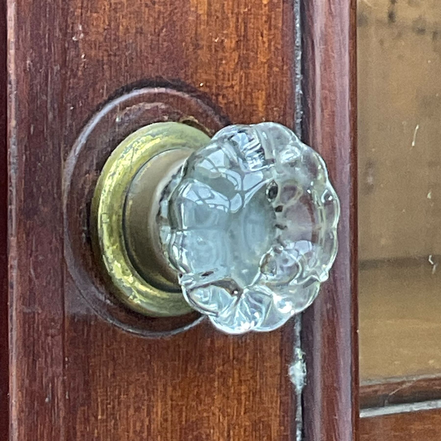 Early 19th century figured mahogany bureau bookcase, projecting splay moulded cornice over three adjustable shelves enclosed by two glazed doors, fall front revealing pigeonholes, cupboard and drawers, pull-out strays with scroll carved terminals, double cupboard with two panelled doors, on turned feet 