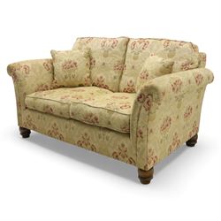 Late 20th century two seat sofa upholstered in floral beige and red fabric, turned supports 