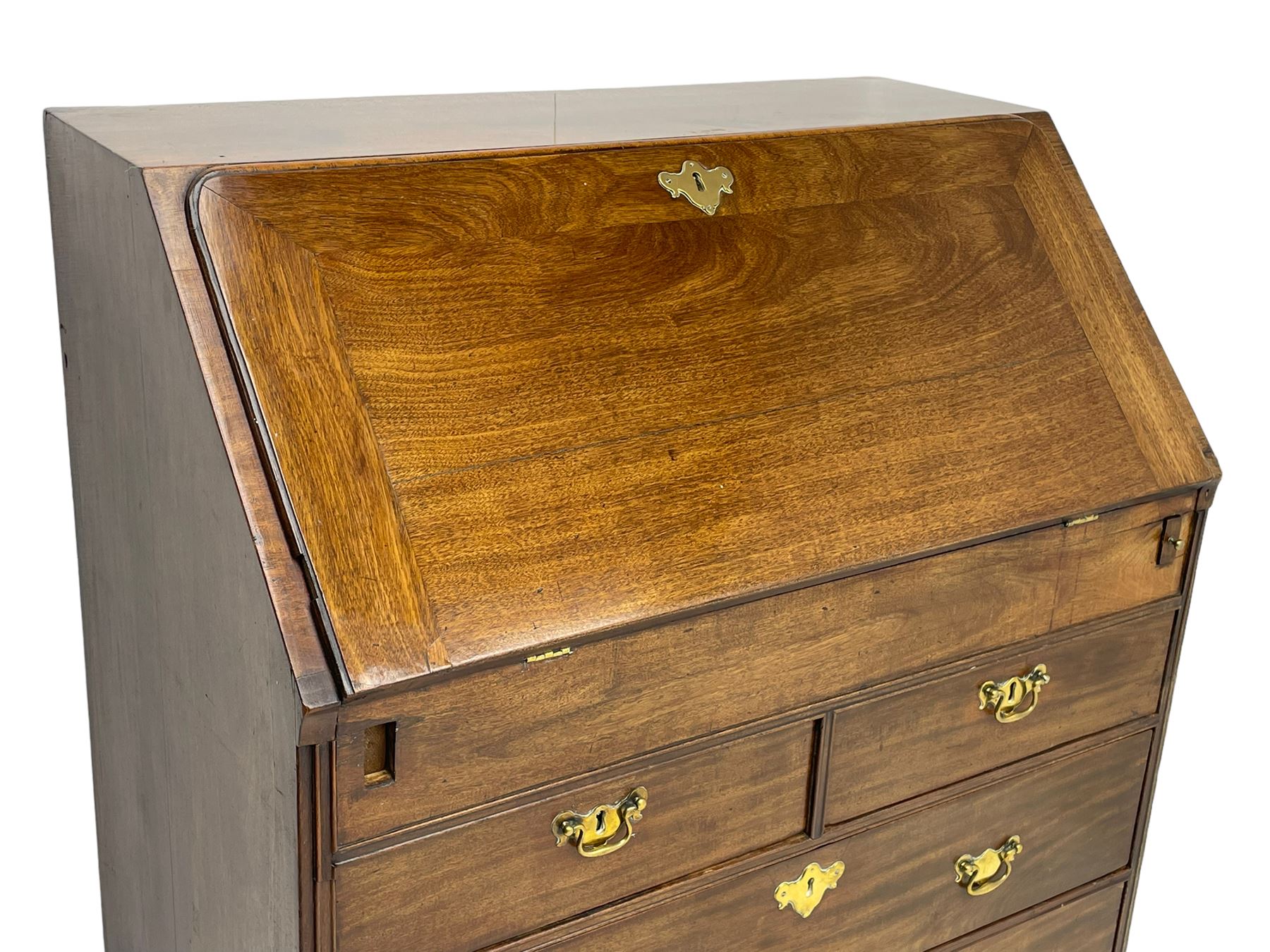 Georgian red walnut and mahogany bureau, moulded rectangular fall front with rounded upper corners, the interior fitted with sliding storage well, a combination of small drawers and pigeons holes, two short and two long drawers below, on bracket feet