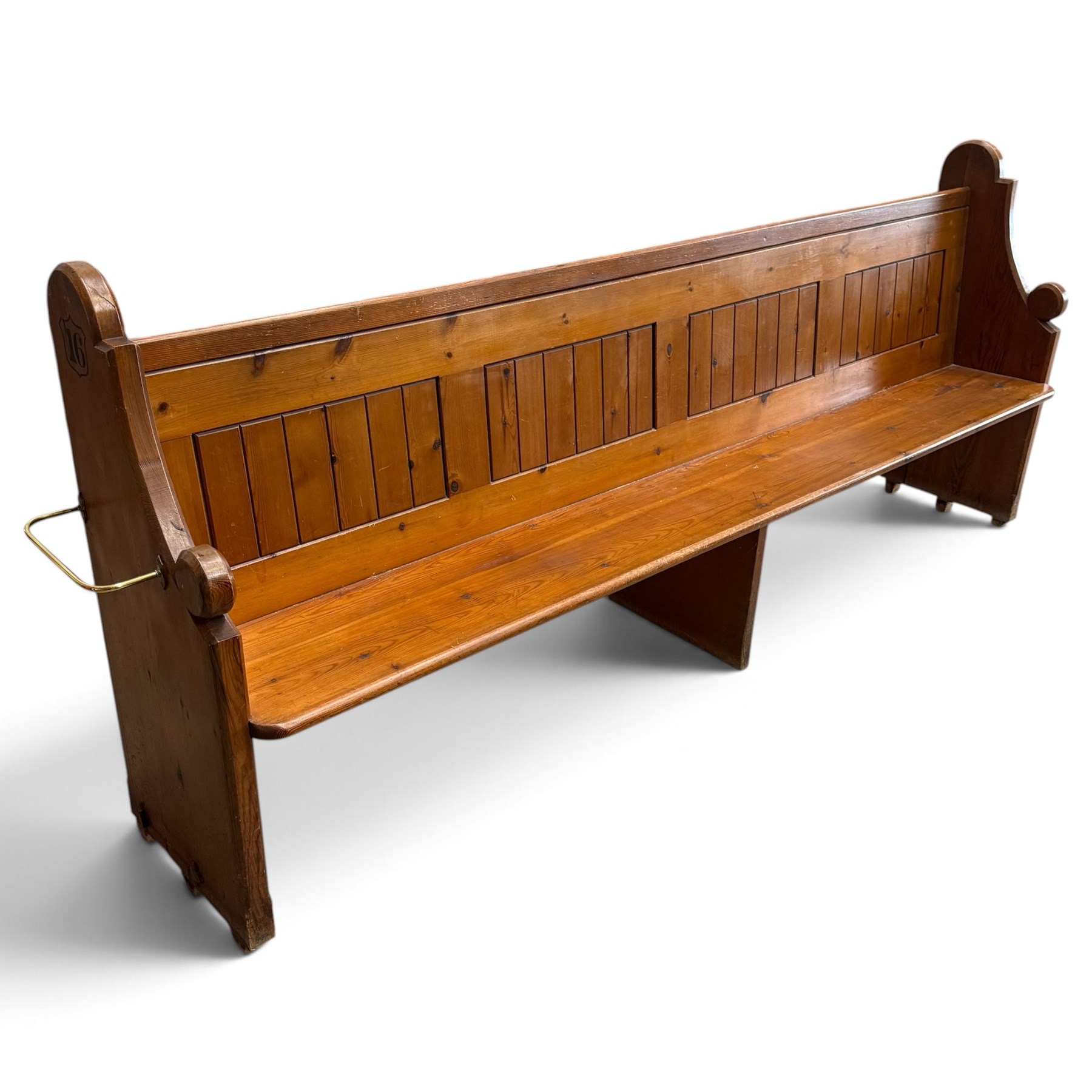 Early 20th century stained pine ecclesiastical church pew, the shaped end supports flanking slatted and panelled back, with black stencilled number '16' to the side