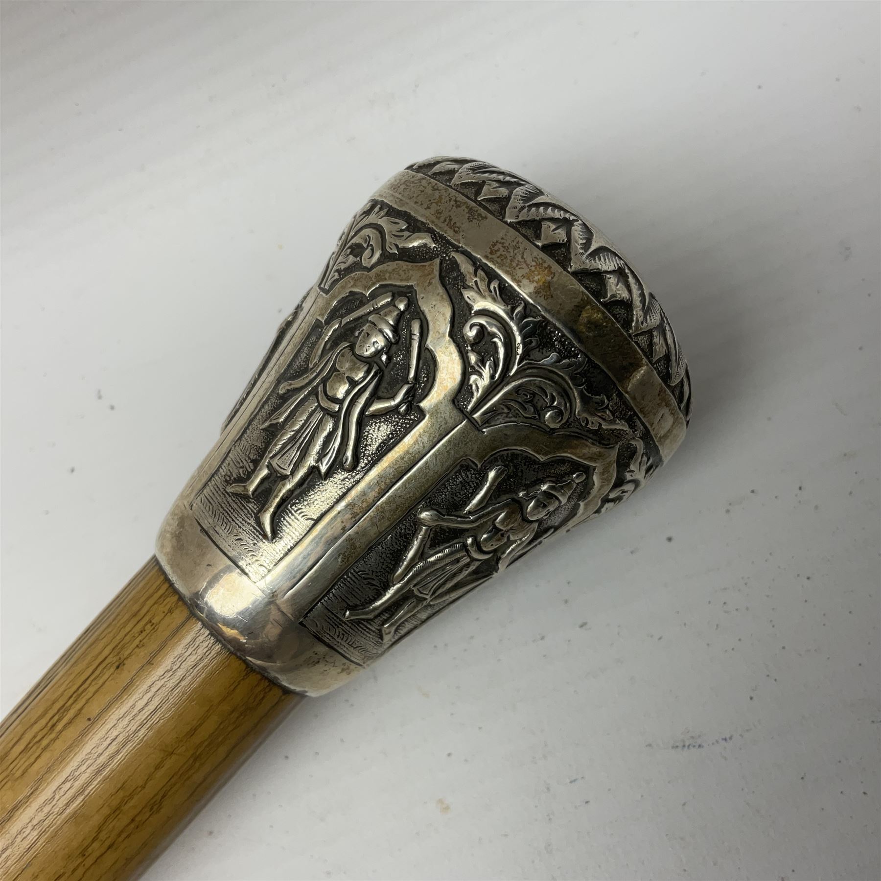 Malacca walking cane, with domed Burmese silver pommel embossed with deities, L91.5cm