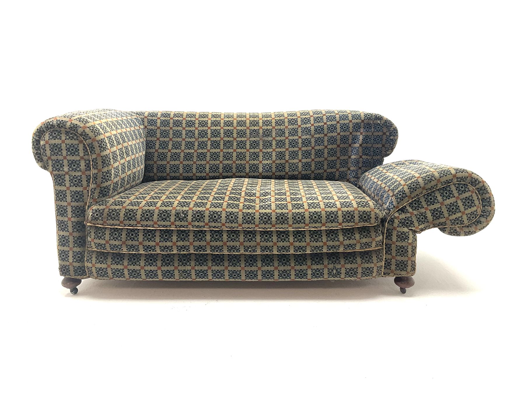 Early 20th century two seater drop arm sofa, upholstered in geometric pattern, turned supports and castors 