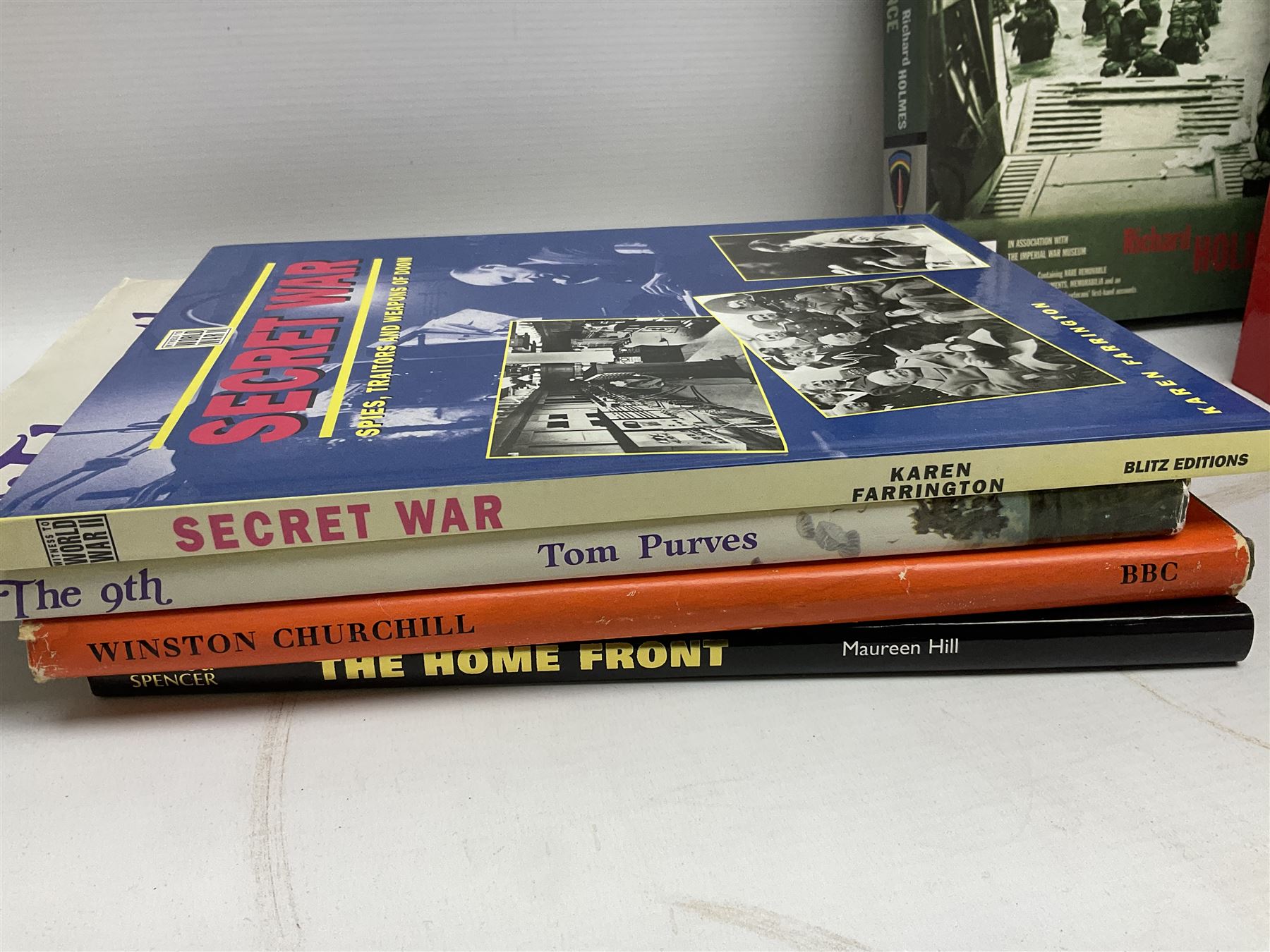 Thirty modern books of military interest including The Wartime Scrapbook 1939-1945; D-Day by Stephen Badsey; The D-Day Experience by Richard Holmes; Desert Rats by John Parker; A Most Secret Squadron by Des Curtis; Flying Colours - The Epic Story of Douglas Bader by Laddie Lucas etc; and quantity of DVDs of war and military interest