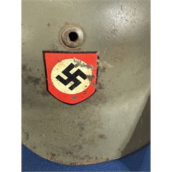 German Third Reich Waffen-SS M35 double decal helmet, the left inner brim stamped SF64, the back inner brim stamped 3866, with leather eight tongue liner and chinstrap