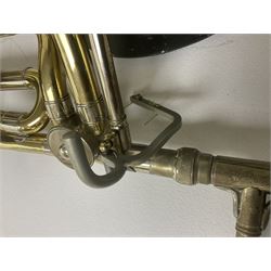 Three brass trombones comprising Elkhart Ind. USA 'CONN' model no.72H; Besson 'Concord'; and Selmer Distributed 'Lincoln'; two in carrying cases; and German B & M 'Champion' brass trumpet (4)