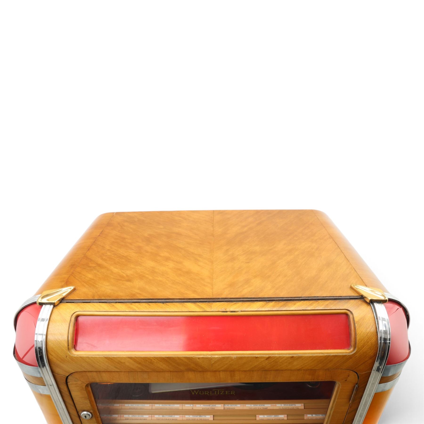 Rudolf Wurlitzer Company - Model 616 'Simplex' 1937 jukebox, figured walnut veneered cabinet with illuminated red and amber side panels enclosed by chromed uprights, glazed upper record compartment, cast Art Deco speaker grille, coin-operated push-button selection panel with circular title index, raised on a moulded base