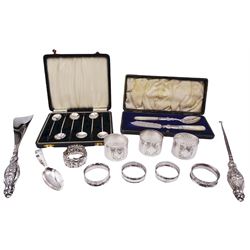Group of silver, comprising eight assorted napkin rings, including set of three early 20th century examples of circular form with planished finish, hallmarked Thomas Bradbury & Sons Ltd, Sheffield 1917, 1919 and 1921, the other examples of various design, with various hallmarks, dates ranging 1878 to 1919, a set of six coffee bean spoons, hallmarked Birmingham 1937, makers mark worn and indistinct, contained within a fitted case, late Victorian spoon and knife set with mother of pearl handles and silver blade and bowl, hallmarked Joseph Gloster, Birmingham 1900, contained within a fitted case, early 20th century silver handled button hook and similar shoe horn, and a mid 20th century baby spoon, approximate total weighable silver (including coffee spoons with bean terminals) 5.80 ozt (180.6 grams)