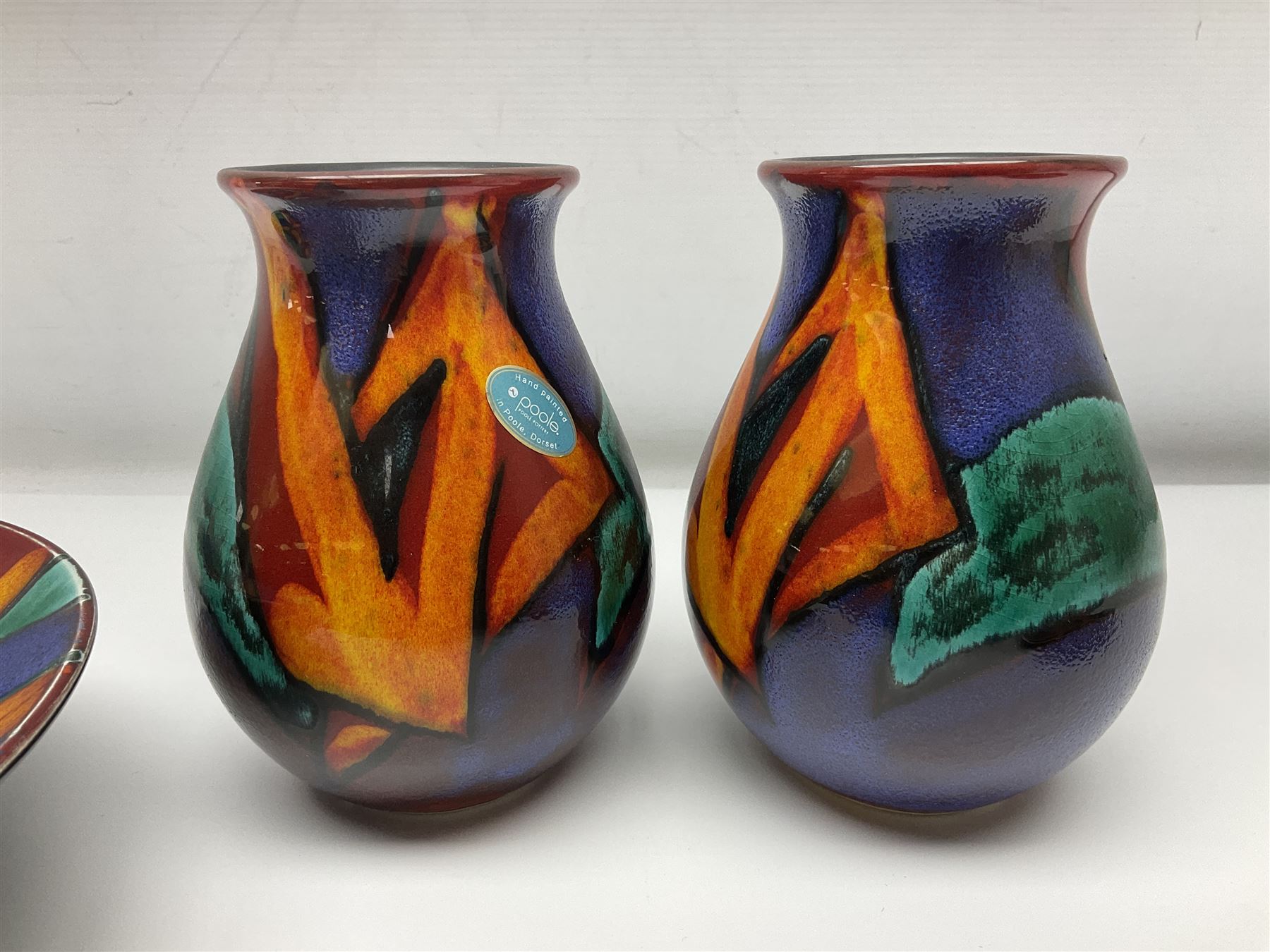 Four pieces of Poole Pottery in Graffiti pattern, comprising pair of vases of baluster form, dish and small plate, with impressed or printed marks beneath, vase H17cm