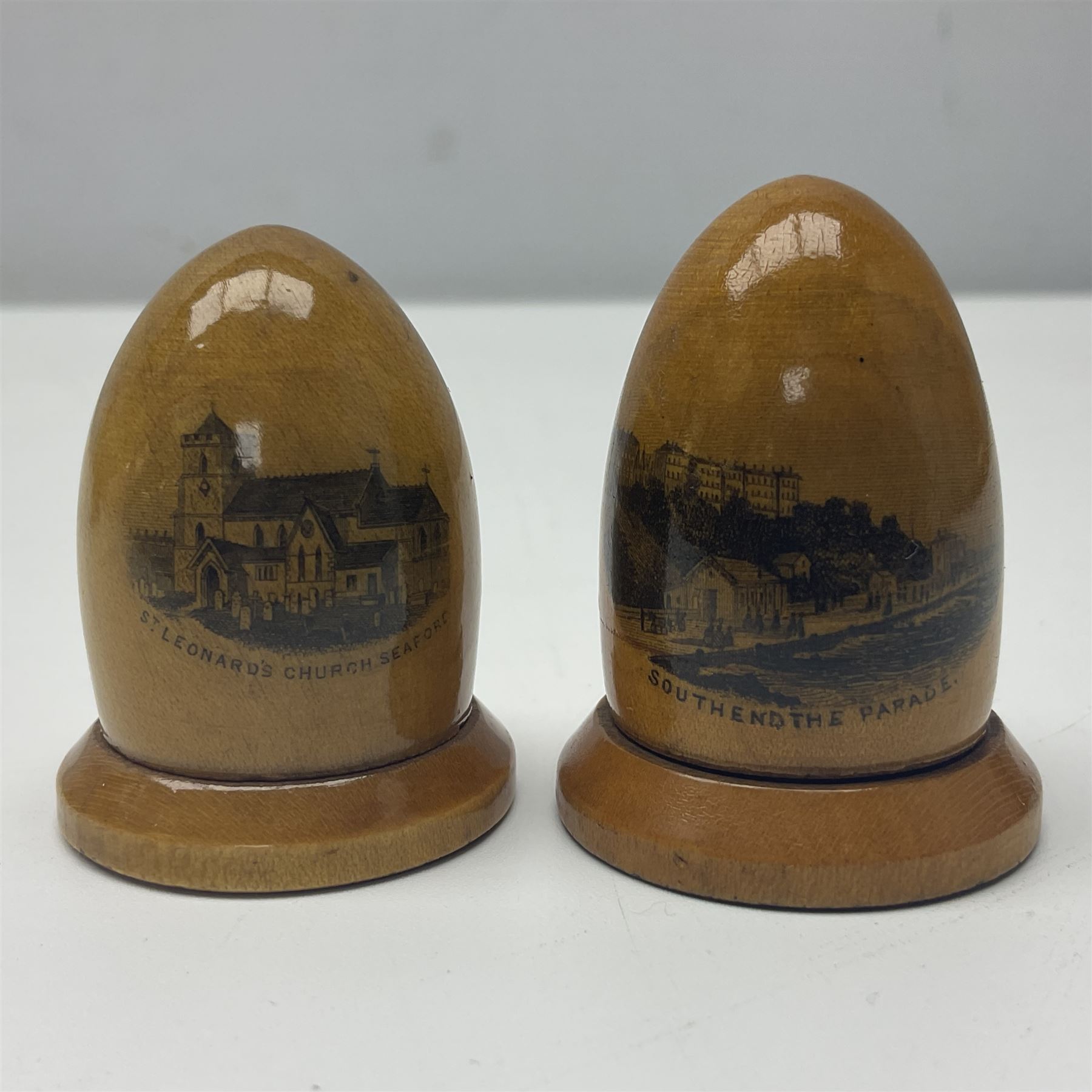 Six sewing related Mauchline ware comprising an oval reel box with internal label for Clark & Co's, tape measure, pin case and three thimble holders of ovoid form 