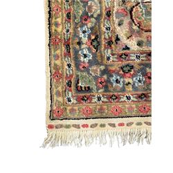 Persian design ivory ground rug, overall floral design with shaped central medallion, the main border decorated with trailing flower head pattern, within guard stipes 