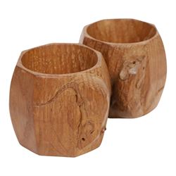 Mouseman - pair of dark oak napkin rings, of bulbous octagonal form with signature mouse carving by Robert Thompson of Kilburn