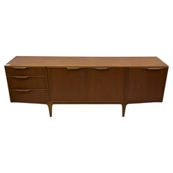 Tom Robertson for AH McIntosh & Co of Kirkaldy - mid-20th century teak 'Dunvegan' sideboard, with three graduating drawers fitted cutlery divider, three cupboards one fall front each with recessed sculptural handles, raised on shaped and tapering supports