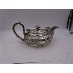 George III Irish silver teapot, of squat circular form, the body with repousse and chased floral and C scroll decoration, with capped C handle and ivory insulators, engraved to base 'Presented to Troop Sergeant Major John Percival, of the 4th Dragoon Guards by Alex D. Tait, Esq, late Captain in that corps as a mark of approbation of his steady and upright conduct when Sergeant Major of his Troop, Dublin, June 2nd 1843', hallmarked William Law, Dublin 1817, H12.5cm, This item has been registered for sale under Section 10 of the APHA Ivory Act