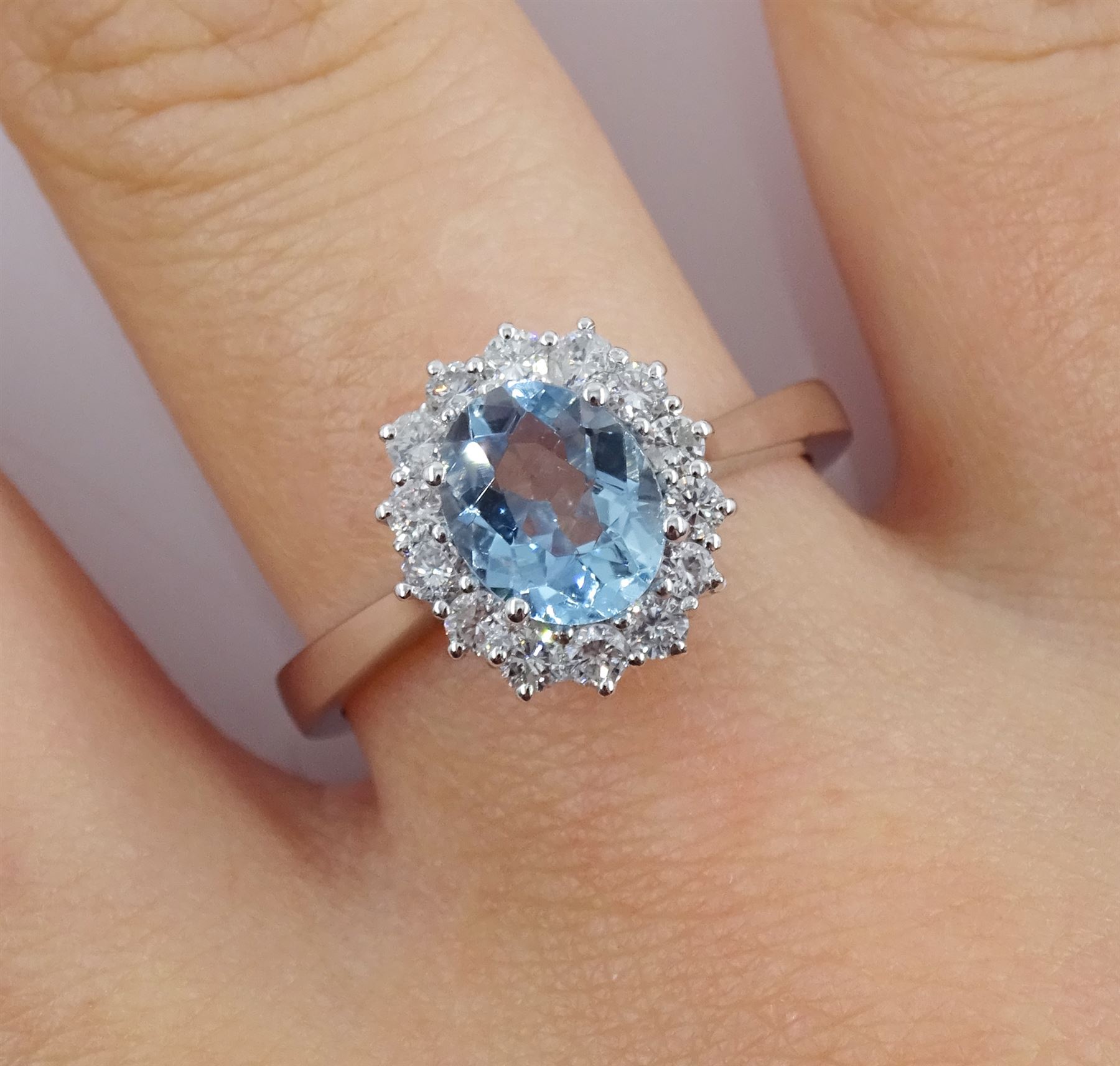 18ct white gold oval aquamarine and round brilliant cut cluster ring, hallmarked, aquamarine approx 1.05 carat, total diamond weight approx 0.40 carat