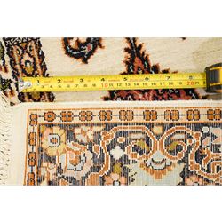 Indian silk-inlaid prayer rug, ivory field decorated with a triple-arched Mirab motif, pendant medallion, paired birds and flowering vases, enclosed by a black ground guard band of scrolling foliage and palmettes