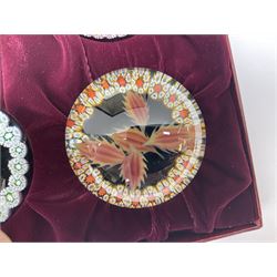 Set of four Caithness paperweights titled Four Seasons, in presentation box with certificate, designed by Colin Terris and made by William Mason, each internally decorated with a seasonal flower within a millefiori cane work garland, numbered 128 of 500