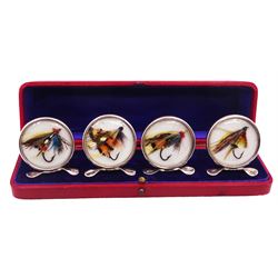 Set of four early 20th century silver mounted place card holders, each of circular form and set with a coloured fly fishing hook behind a glazed panel, upon three pad feet, hallmarked Grey & Co, Chester 1912, H4.5cm, contained within red fitted case, with purple silk and velvet interior