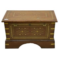 Zanzibar chest, early 20th century, of hardwood construction with brass inlaid foliate and geometric decoration to the lid, fitted interior of multiple carved compartments, with brass strapwork, side handles, and shaped bracket feet