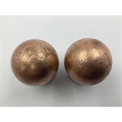 Pair of copper spheres, upon carved wooden bases, D5cm 