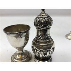 Collection of silver, to include mid 20th century napkin ring, Victorian shaker ornately decorated, hallmarked Chester 1895, trumpet vase with filled base, egg cup and another napkin ring, all stamped with hallmarks, Total weight - 141g, without vase 113g