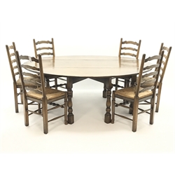  Medium oak oval drop leaf wake dining table on turned gate leg base (L198cm x W156cm, max measurements) and set six ladder back dining chairs with drop in rush seats (W49cm)  