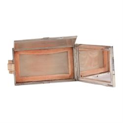 Mid 20th century French silver and gold vanity case, of rectangular form, the hinged cover decorated with an openwork panel of bids and cabochon ruby studded flower heads, opening via a pull clasp to reveal a mirror to the underside and compartment with lift up cover, signed J. Lacloche Paris Cannes, and bearing French assay marks, not including clasp L10cm W6cm D1.5cm

