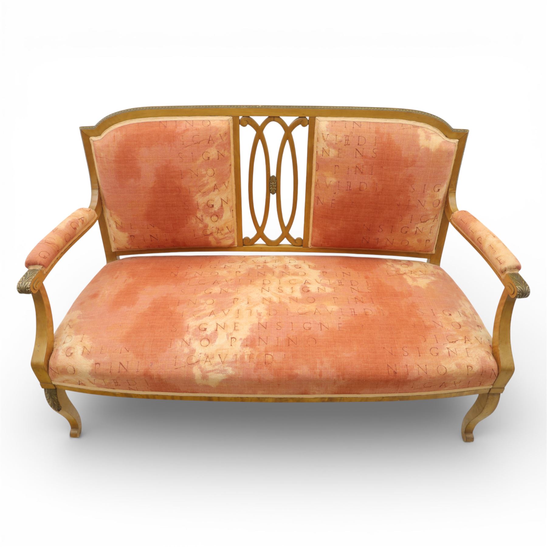 Edwardian satinwood settee, the shaped and bowed top rail enclosing a pierced splat with interlaced oval slats, flanked by upholstered back panels, the padded arms with scrolling terminals, the upholstered seat raised on cabriole supports with pad feet