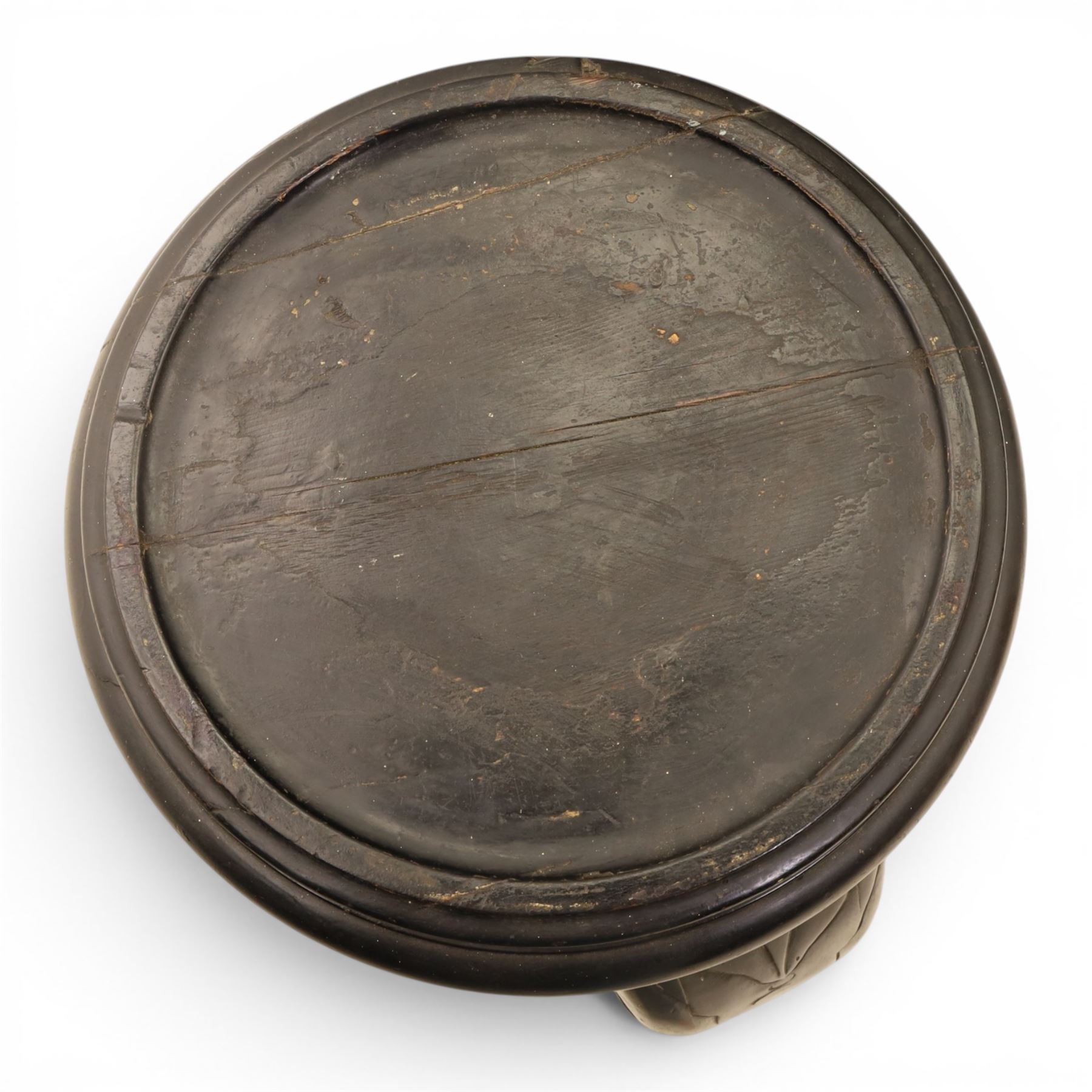 Oriental design black lacquered jardinière stand, circular moulded top with raised rim, the base formed as three elephant heads with carved ears and simulated tusks, on shaped supports with paw terminals