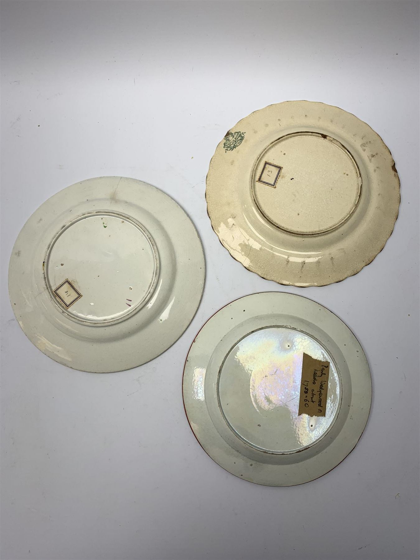 Three 18th/19th century nursery plates, comprising example decorated with central printed chinoiserie scene of pagoda, fence and two figures with bird, within a moulded swag and patera border, D18cm, a William Smith & Co example decorated in the Napoleon pattern with moulded floral border, with printed mark detailed Napoleon WS&Co and faint impressed mark WS&Co's Wedgewood beneath, D18cm, and a pearlware example decorated with chinoiserie figural scene within a moulded border, with overpainted decoration, collectors label beneath inscribed 'Early Wedgwood or Leeds 1750-60', D16cm

