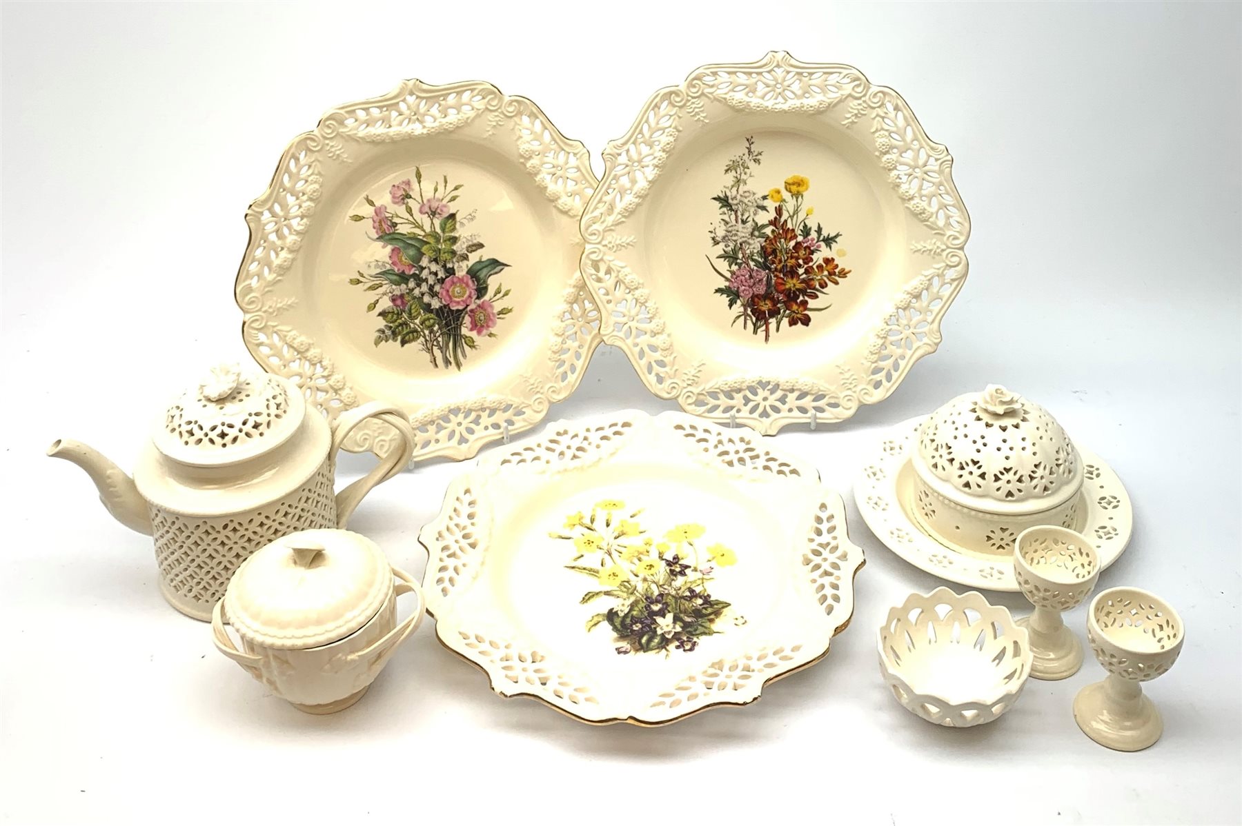 A group of Leeds Creamware, comprising a tea pot, pot and cover, plate, bonbon dish, and egg cups, all with pieced decoration, and a further pot with associated cover, a number of pieces marked beneath Leeds Pottery, plus three Royal Creamware plates. 