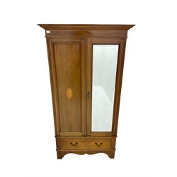 Edwardian inlaid mahogany wardrobe, projecting cornice over bevel edge mirrored door, single drawer below, on shaped apron with bracket feet