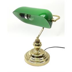 A brass bankers desk lamp, with adjustable green glass shade and stepped circular base, overall approximately H38cm. 