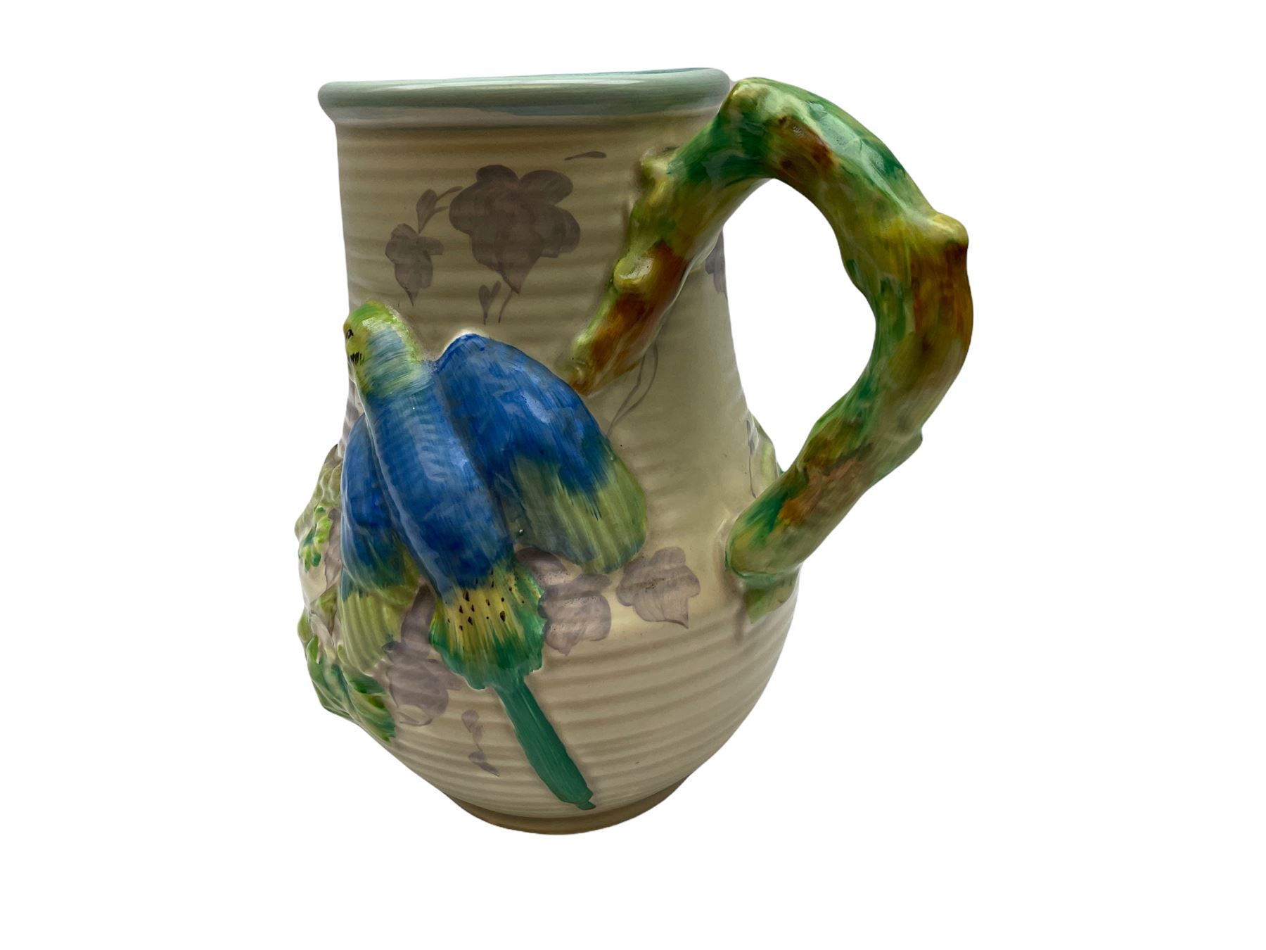 Clarice Cliff baluster jug moulded with a blue budgerigar perched upon branch with green rustic handle and mushroom glaze,  factory stamped beneath, H22.5cm