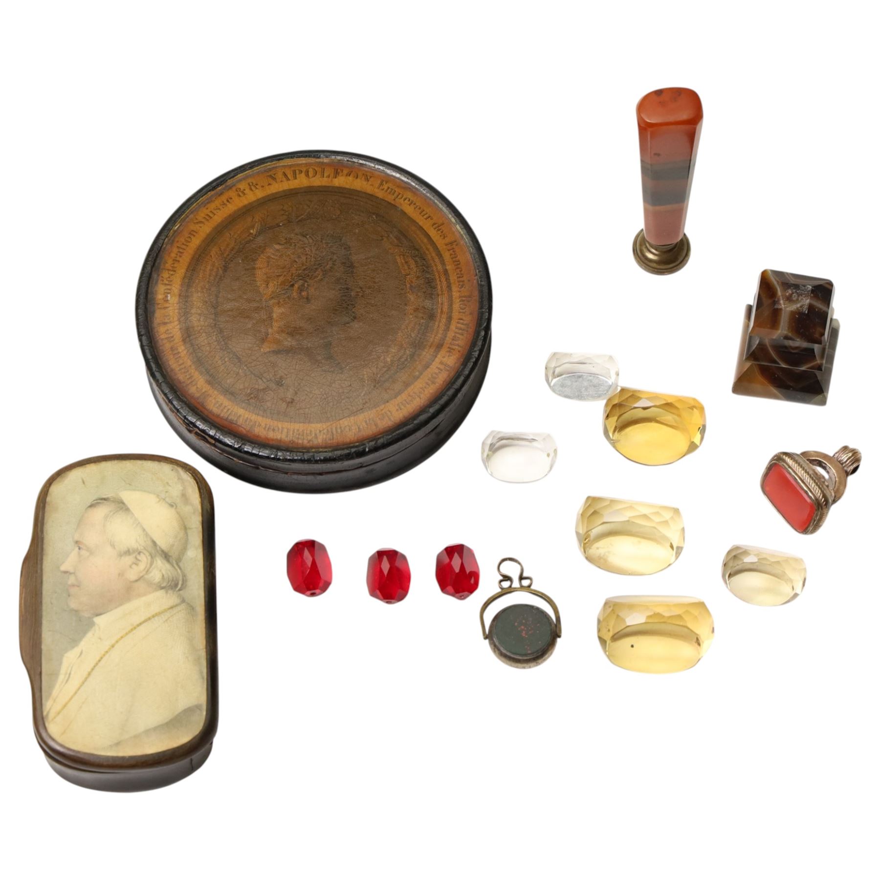19th century papier mache snuff box, the cover with a papal figure, possibly Pope Pius, a French circular snuff box decorated with details of the life of Napoleon Bonaparte, pinchbeck seal, agate desk seal and various others