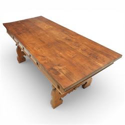 20th century Spanish design oak dining table, large rectangular top above a run of three drawers to the frieze, standing on shaped trestle supports with scroll cut details and stretcher base