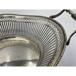 Early 20th century Dutch silver basket, of oval form with pierced sides, beaded rim, and twin handles, marked with Lion Passant for 2nd standard purity and date letter for 1910, other marks worn and indistinct, including handles H8.5cm L25.5cm