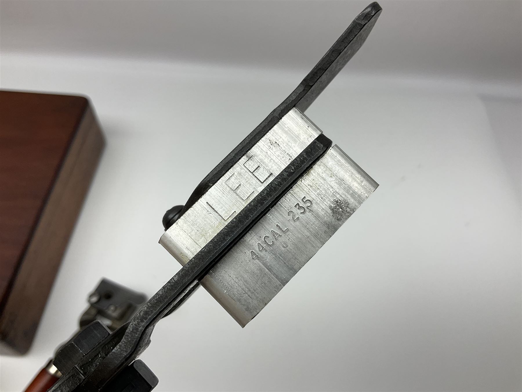 Three modern bullet moulds comprising Lee double cavity .44 calibre, boxed with instructions; and two Lyman .38 calibre; all in unrelated 19th century mahogany box