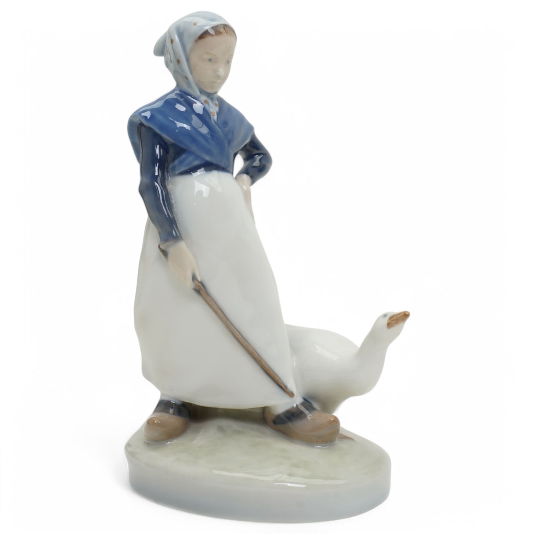 Four Royal Copenhagen figures, including Amager Girl Sewing no. 1314, Boy Whittling no. 905, Girl with Goose no. 528, and Amager Girls Reading no. 1395