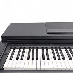 Yamaha Clavinova CLP-550 digital piano, full-size weighted keyboard with integrated pedals and speakers, in dark wood effect casing, accompanied by matching padded bench, Sennheiser headphones, original manuals, and factory-issued cassette tape titled 'Pure & Simple – CLP Digital Pianos'