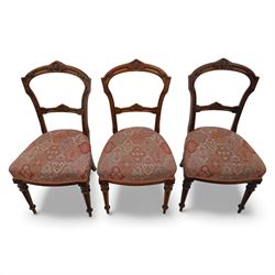 Set of six late Victorian mahogany dining chairs, the shaped top rails carved with anthemion motifs, above pierced splats, floral and geometric fabric seat, on turned and fluted front legs