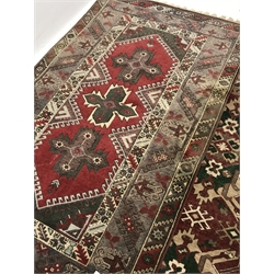Turkish red ground rug, geometric design, the field decorated with three star motifs (198cm x 120cm), and another Turkish red ground rug decorated with two large geometric stars (198cm x 142cm)