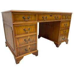 Georgian design yew wood twin pedestal desk, moulded rectangular top over nine cock-beaded drawers, on bracket feet
