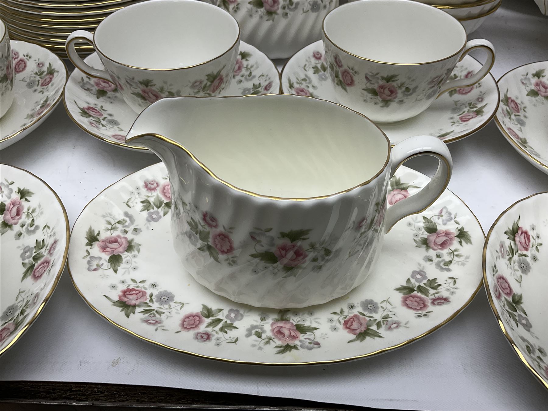 Minton Spring Bouquet pattern dinner and tea service, comprising dinner plates, twin handled tureens with covers, meat platter, teapot, milk jug, sugar bowl with cover, tea cups and saucers, bowls, cake plate, side plates, dessert plates, etc all with printed mark beneath (82)
