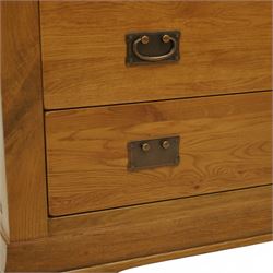 Contemporary solid oak five drawer chest, the rectangular top with inset panels over two short and three full-width drawers, all with brass-effect drop handles, raised on a plinth base