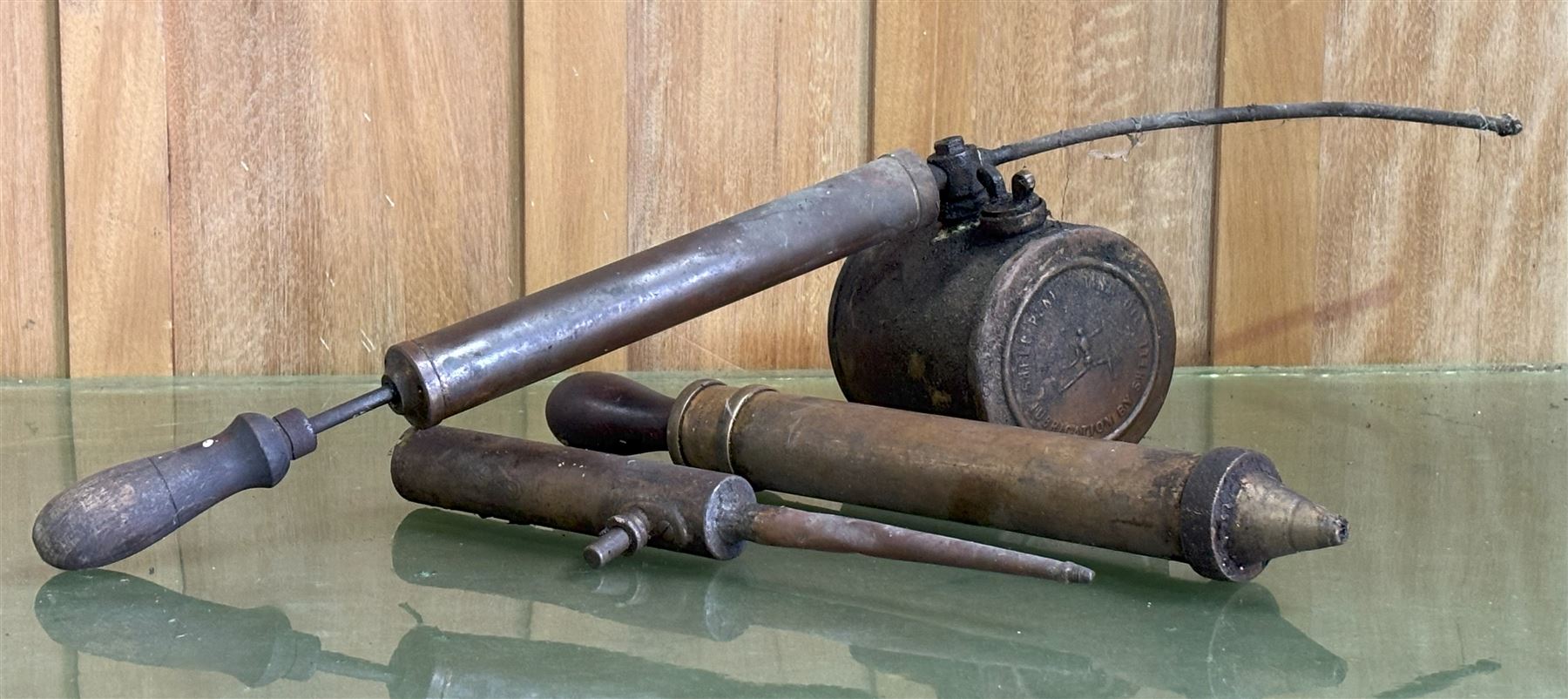 Rare early Shell advertising brass penetrating oil can, the can embossed to each side with the stick / robot man motif, and reading 'Penetrating oil can lubrication by Shell' (L71cm) together with two other early motoring oil hand pumps, one signed 'Erot' and the other 'Nesthill Royalty PAT.' (3) - COLLECTION BY APPOINTMENT FROM: The White House, Thirsk Road, Easingwold, York, YO61 3NF - CALL 01723 507111 TO ARRANGE