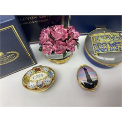 Halcyon Days bonbonniere, modelled as pink roses in a planter painted with a blue and white Japanese scene, together with five Halcyon Days enamel boxes, one a larger example depicting 'The Becket Casket' and four smaller boxes, including The 1993 Easter Egg, Happy Birthday and Statue of Liberty examples, all boxed, Becket Casket D8cm