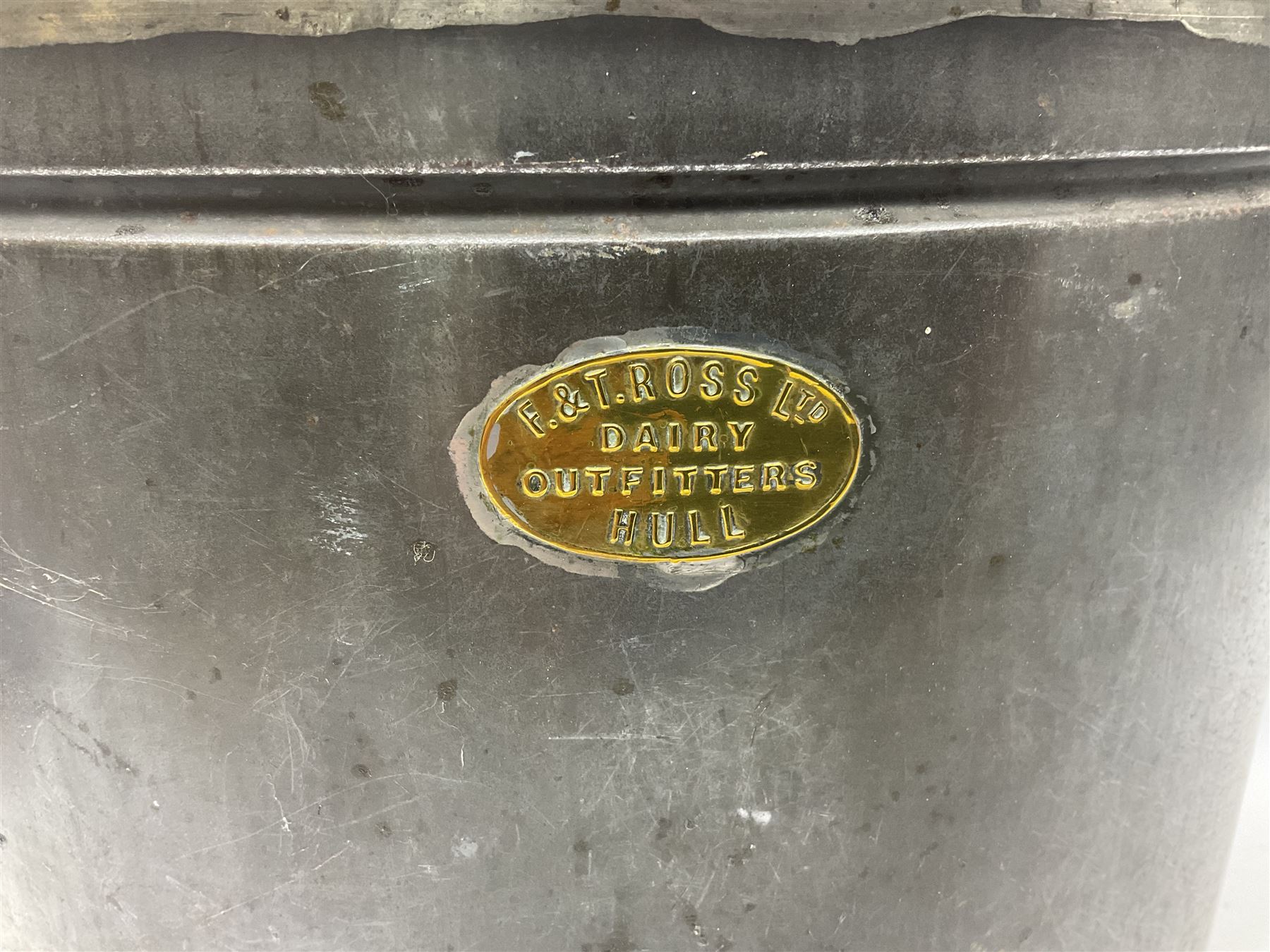 Late 19th/early 20th century steel and brass dairy pail or can, of oval form with swing handle, brass plaque to front and hinged cover inscribed 'F & T Ross Ltd Dairy Outfitters Hull', and 'New Milk F Clappison Dairy Farmer Hull', not including handle H30cm