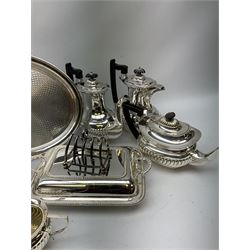 A silver plated six bottle cruet stand, upon four scroll feet, together with other silver plate, to include a five piece silver plated coffee set, two trays, etc.