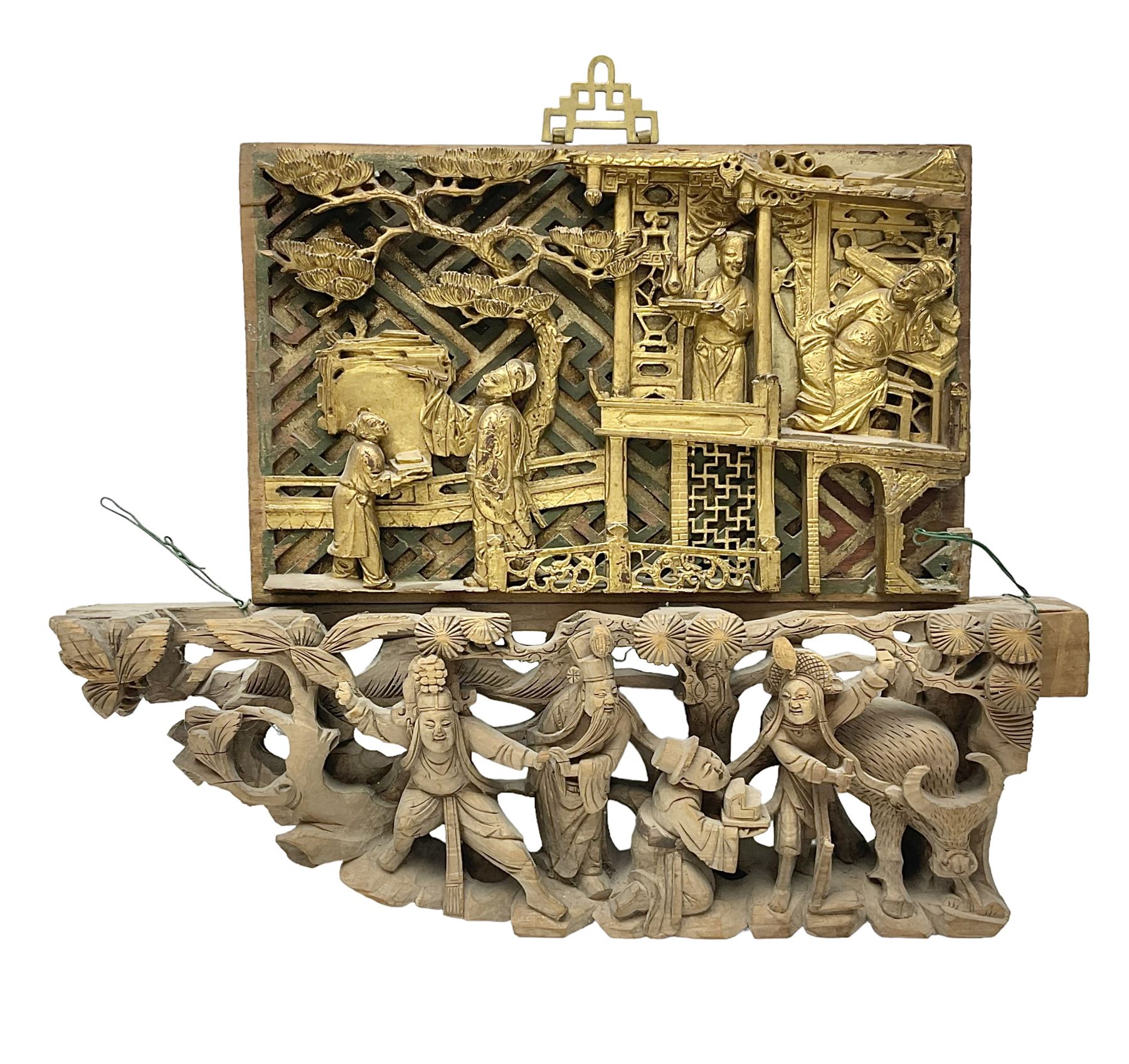 Two carved oriental wall hangings, the first example gilded depicting a temple and garden scene, the second figures in a garden, L49cm