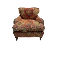 Early 20th century Howard style armchair, upholstered in Kilim fabric with sprung seat, hardwood frame, square tapering supports with brass and ceramic castors